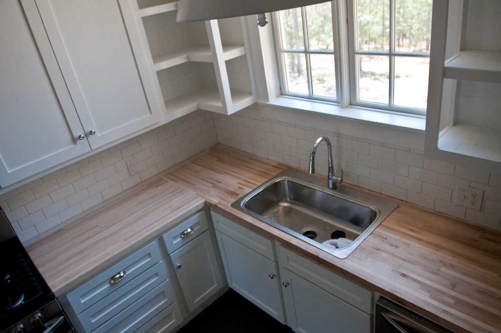 A white kitchen with butcher block counters