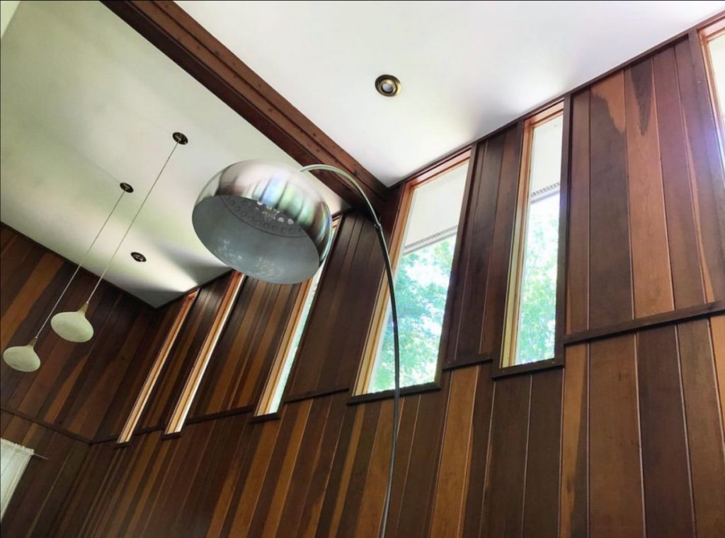 A view toward the ceiling of the mid century modern house, with a period appropriate lamp.