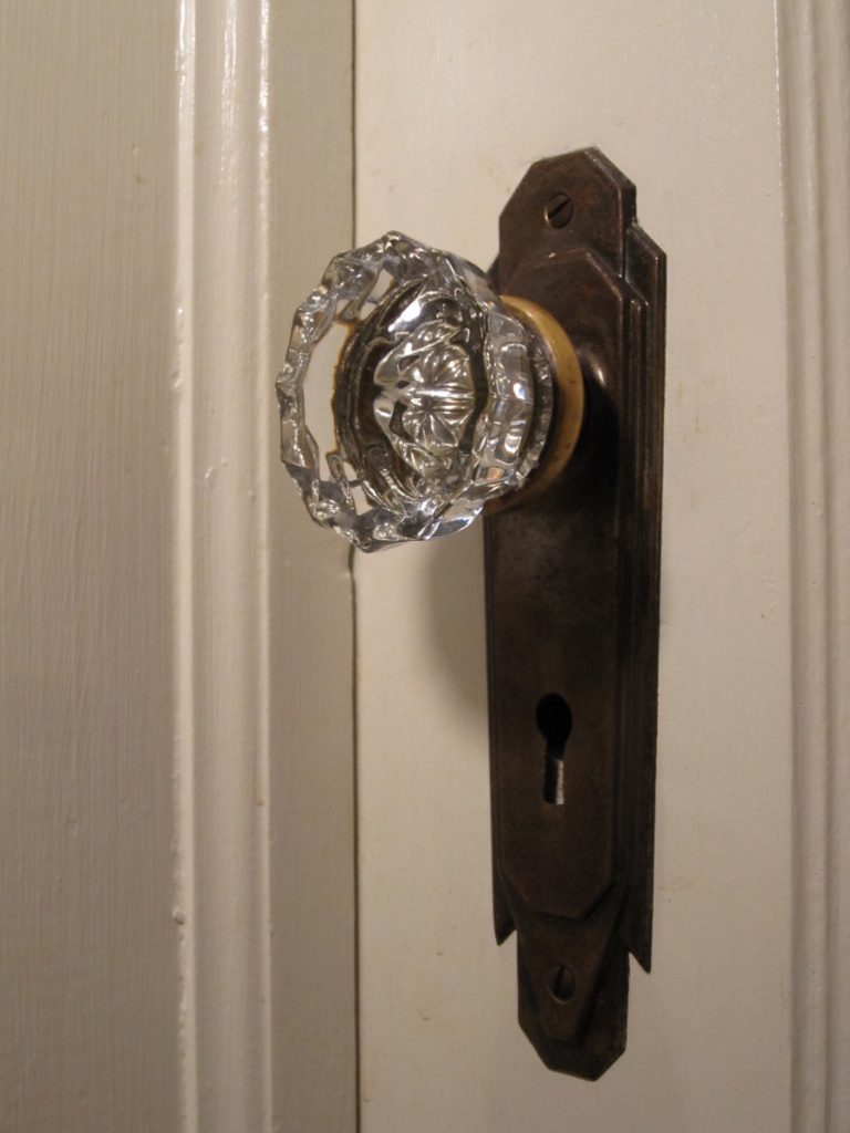 A close-up of an antique glass door knob.