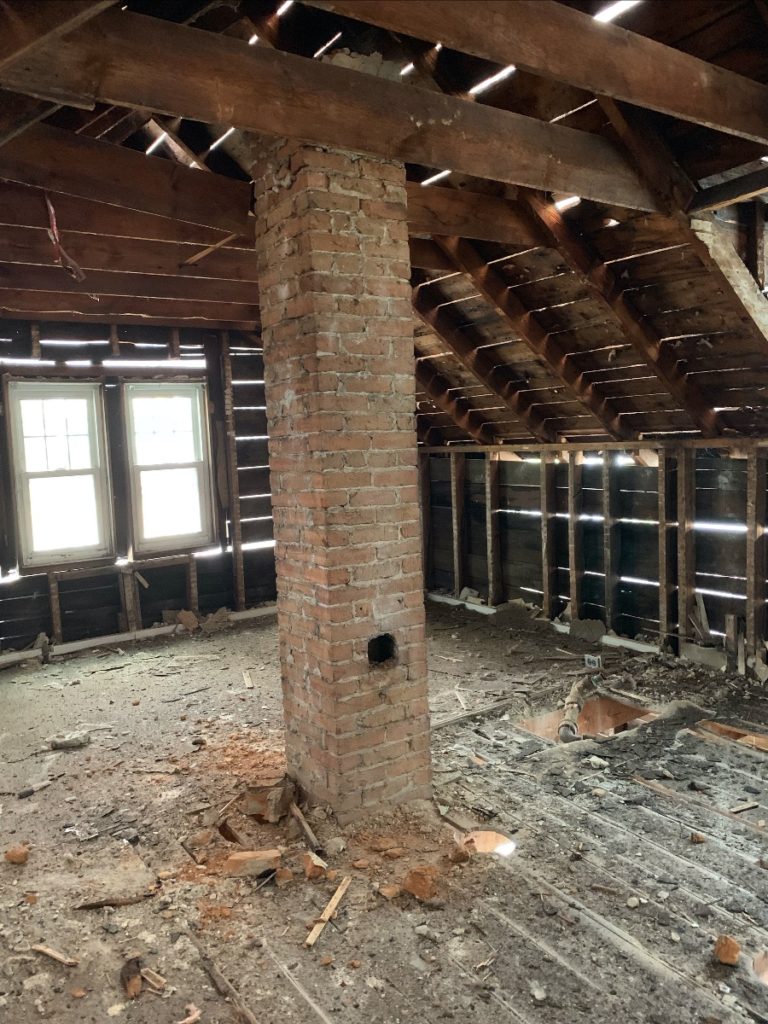 An old brick chimney during a gut renovation. 