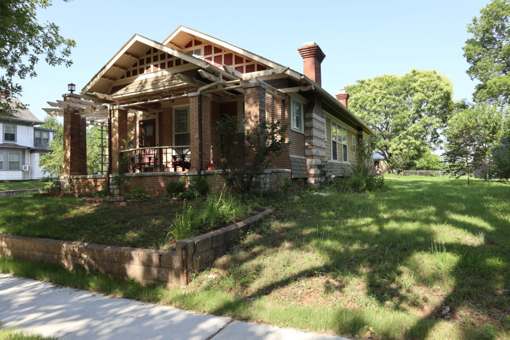 The bungalow from the back yard. It has a charming back porch.