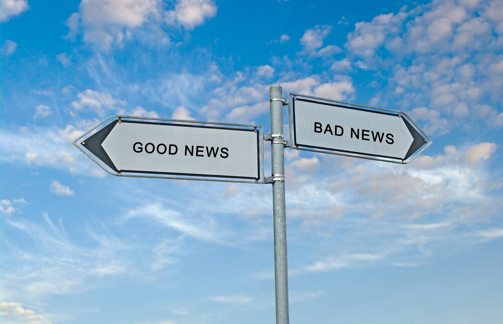 Two signs pointing in opposite directions. One says "Good news," the other "bad news."