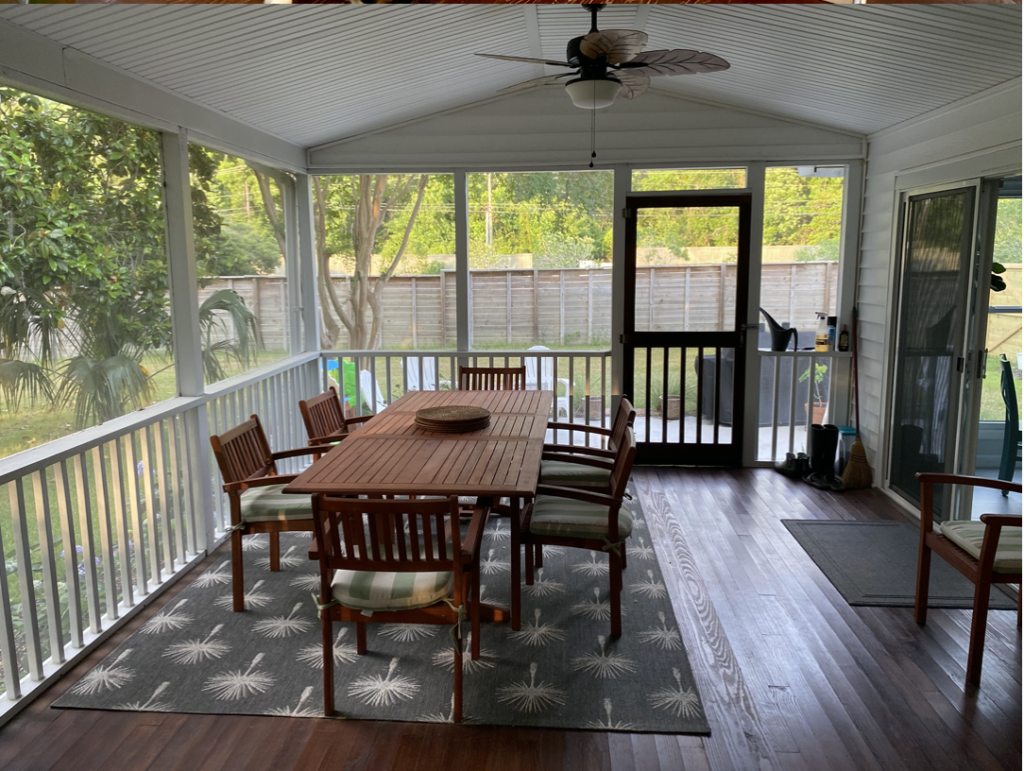 A dining set on a newly renovated screened porch. 