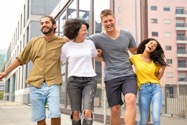 A group of young people joyfully walking down the street.